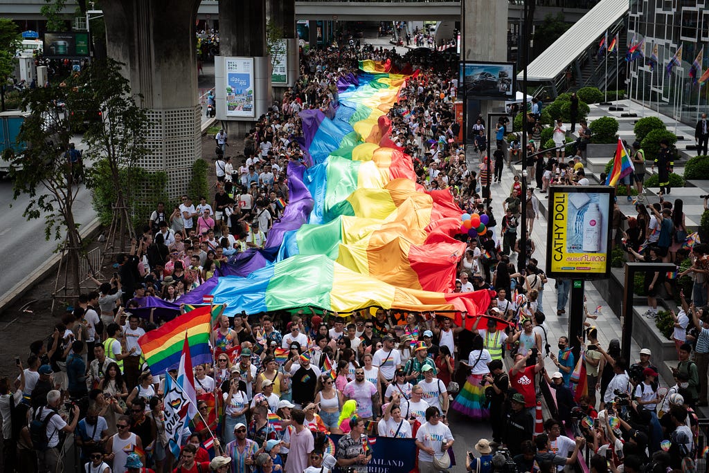 A massive Pride flag is extended down the streets of Thailand to celebrate the legalization of same-sex marriage.