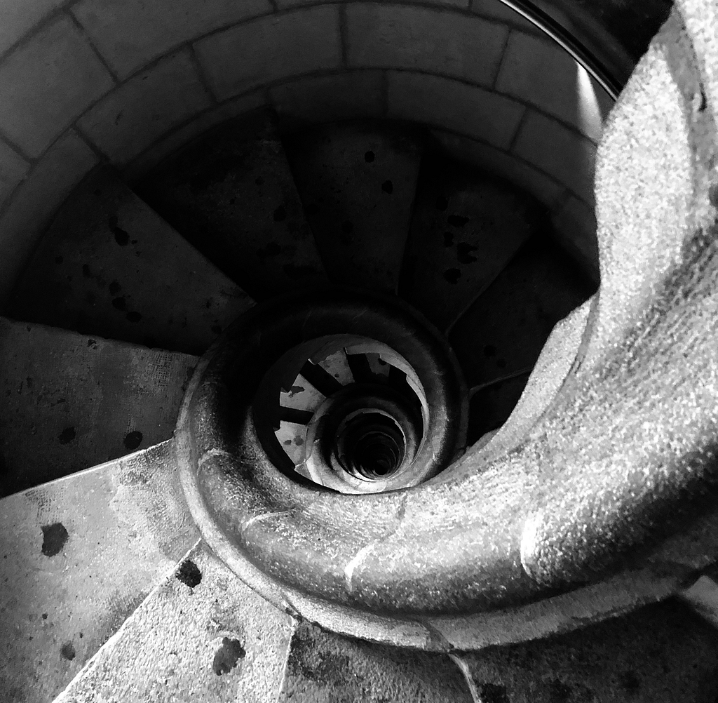 Peering down at a spiral staircase. Black and white photo