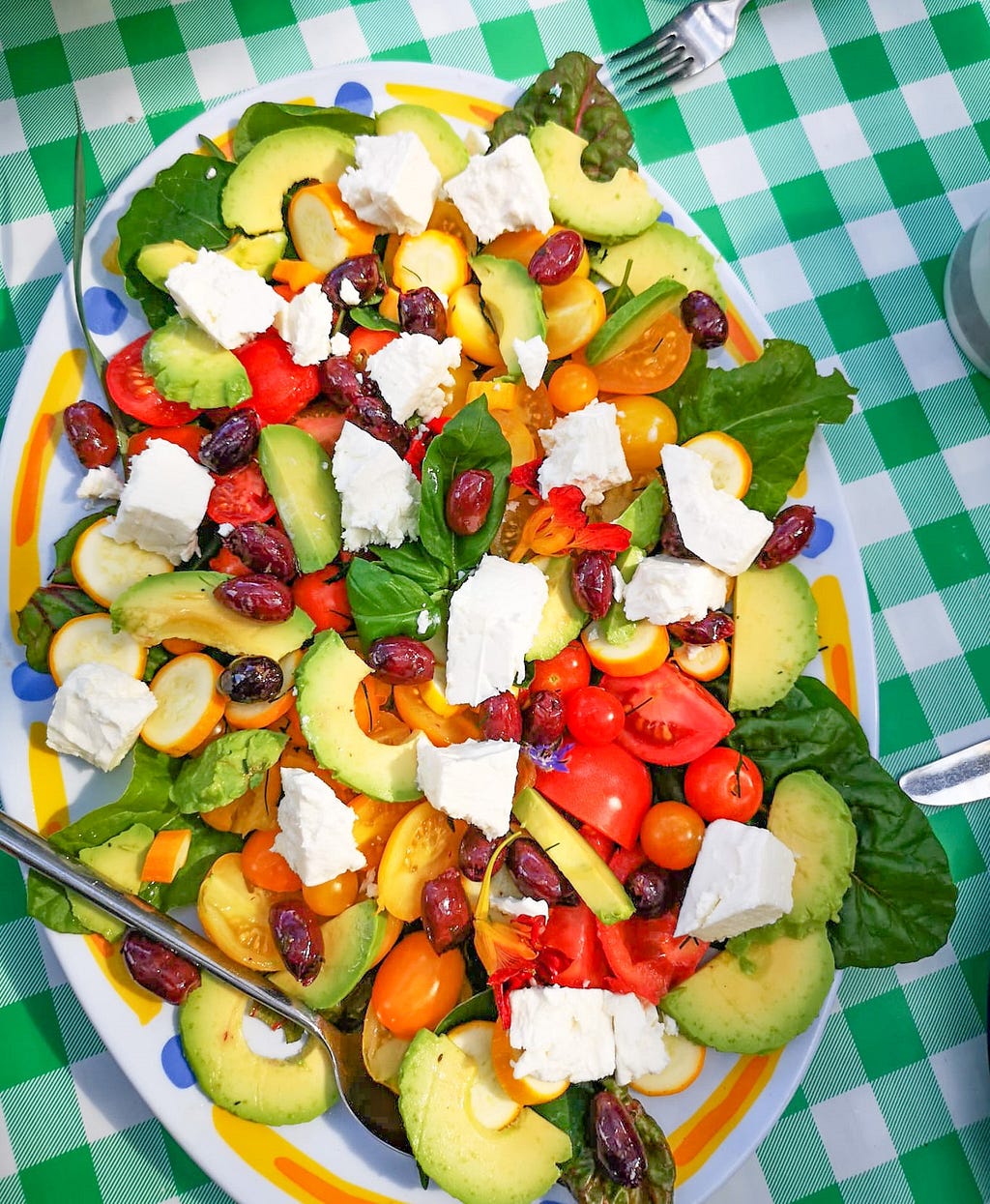 Large sharing plate of salad — multicoloured red and green vegetables