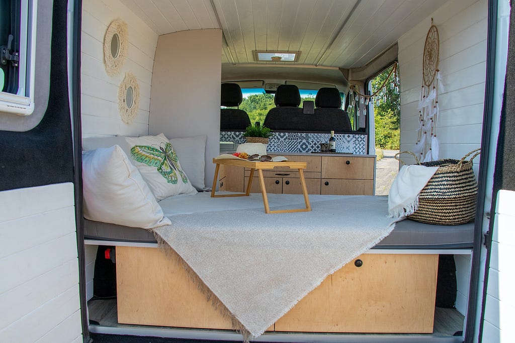 Campervan interior showing bed and desk