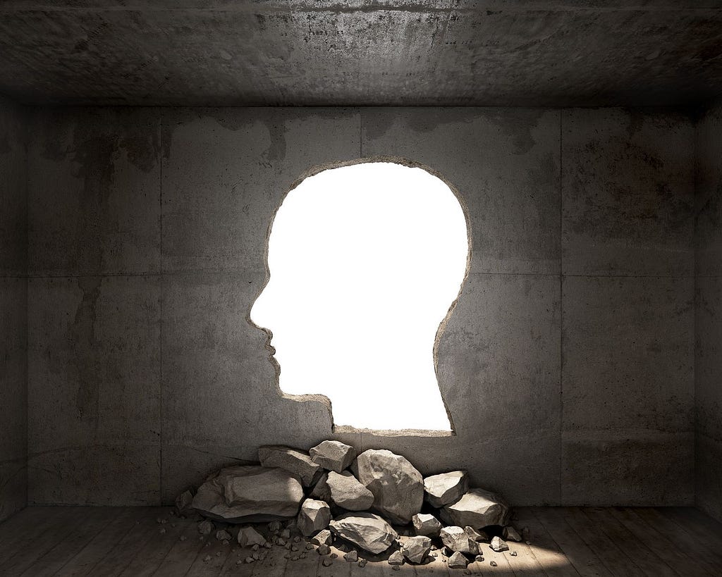 Head shape cut out of a wall, letting light in.