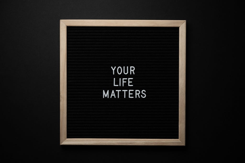 Black background with gold frame. In the frame the three words “Your Life Matters” is written in white block letters.