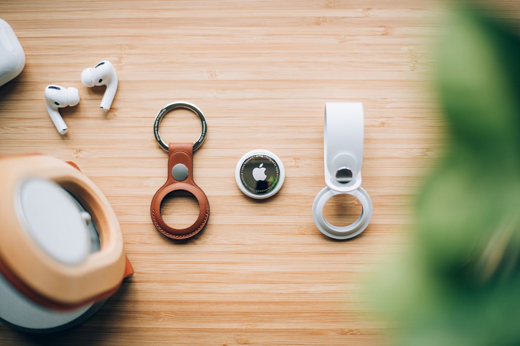 Apple Air tags along with, Air pods pro on a wooden surface.