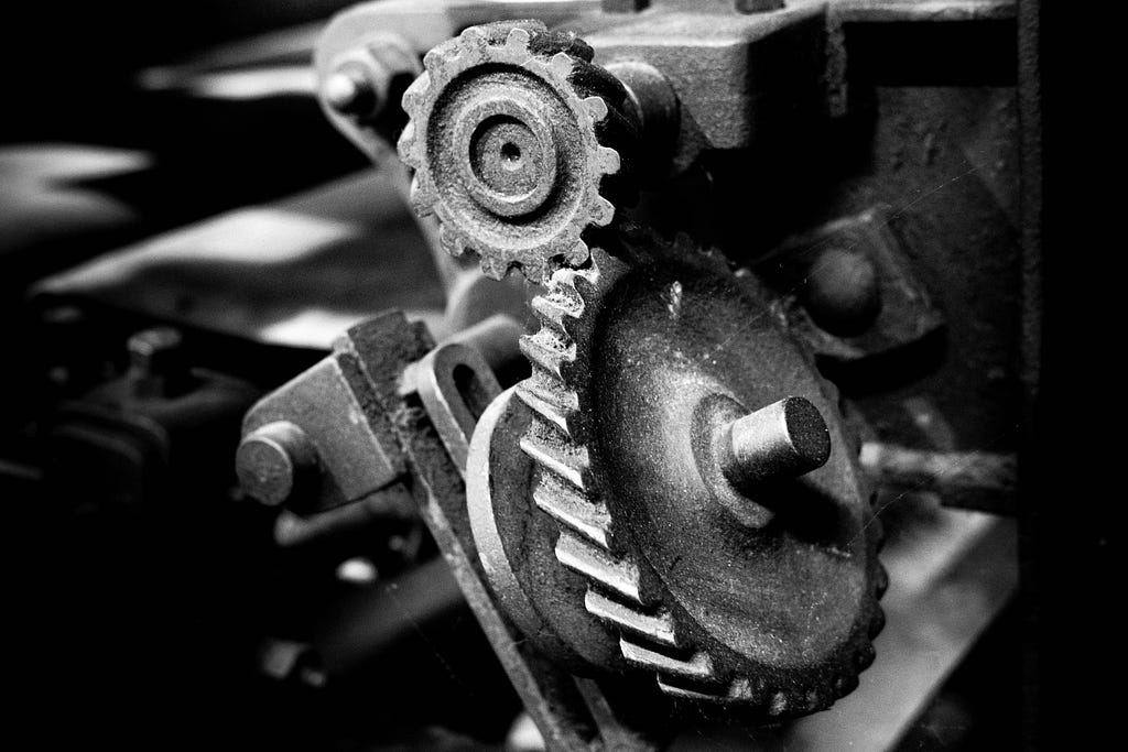 Black and white photo of two metal gears in a machine.