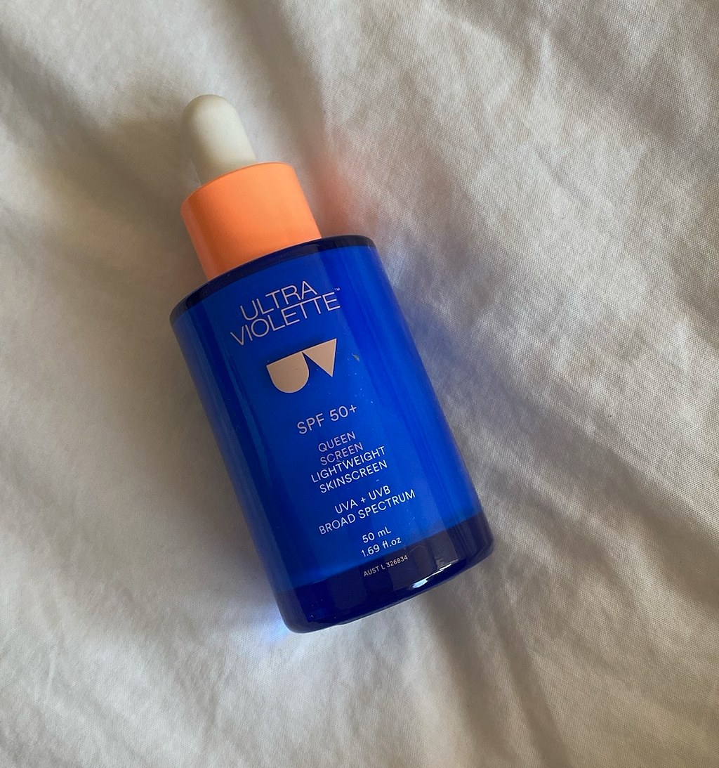 Small glass bottle with the words ‘Ultra Violette SPF Queen Screen SPF 50+ Broad Spectrum’. There is an orange pipette and a small triangle logo.