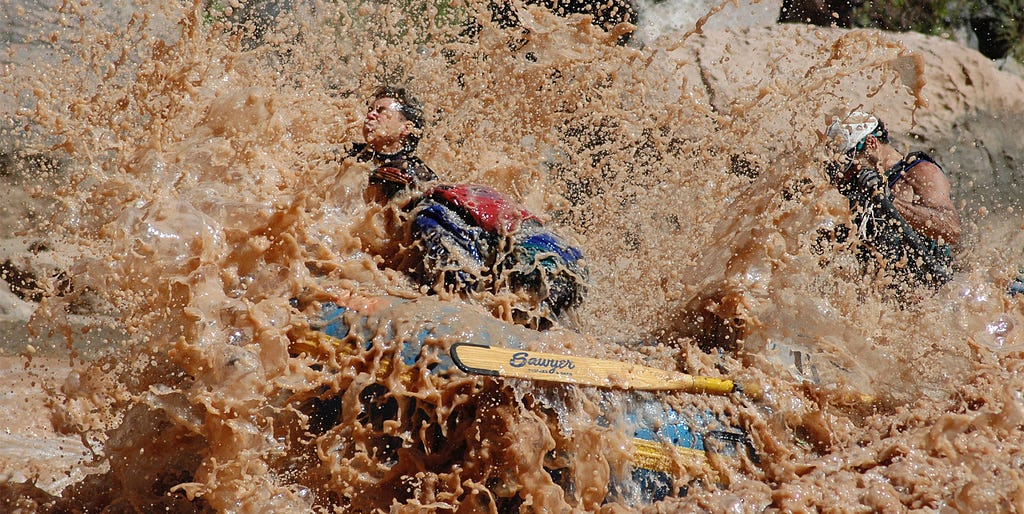 Author rowing through massive wave in Hermit Rapid, Grand Canyon.
