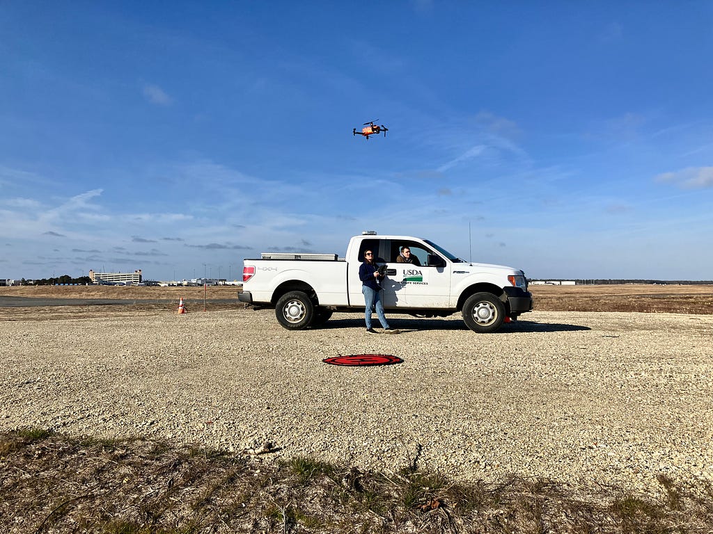 USDA truck and certified drone operators operating a small drone.