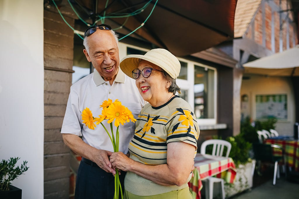 Elderly Couple holding a bouquet