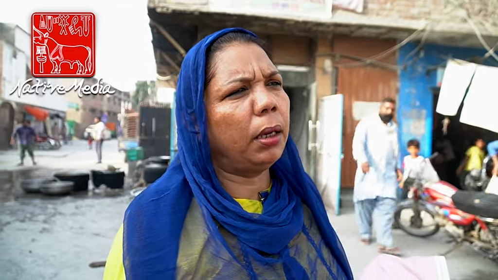 A woman speaks to the camera in a Christian neighbourhood in Lahore, Pakistan