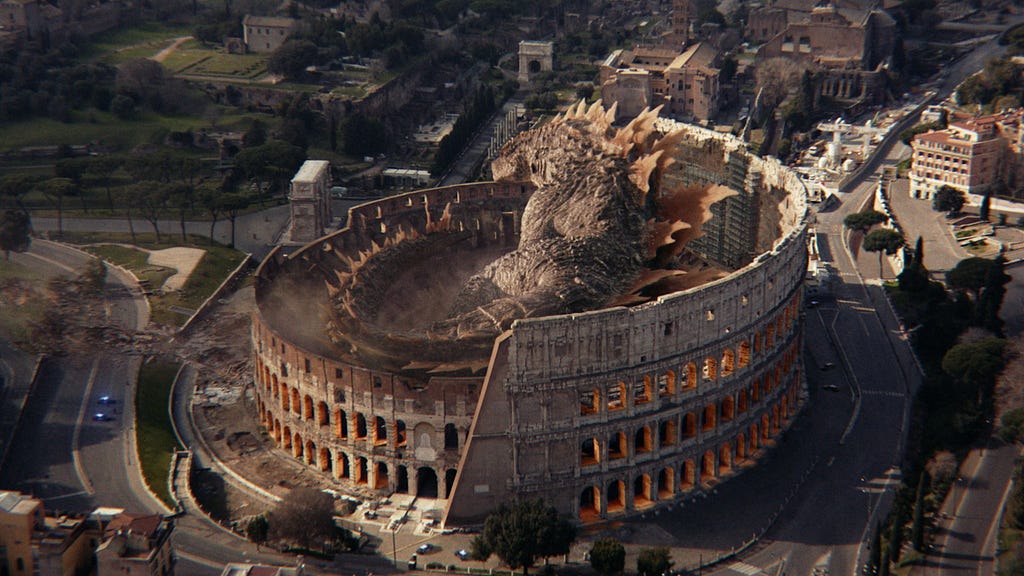 A screencap aerial shot of Godzilla about to take a nap in The Colleseum.