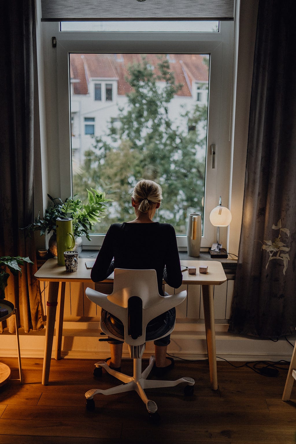 Woman working at desk by window
