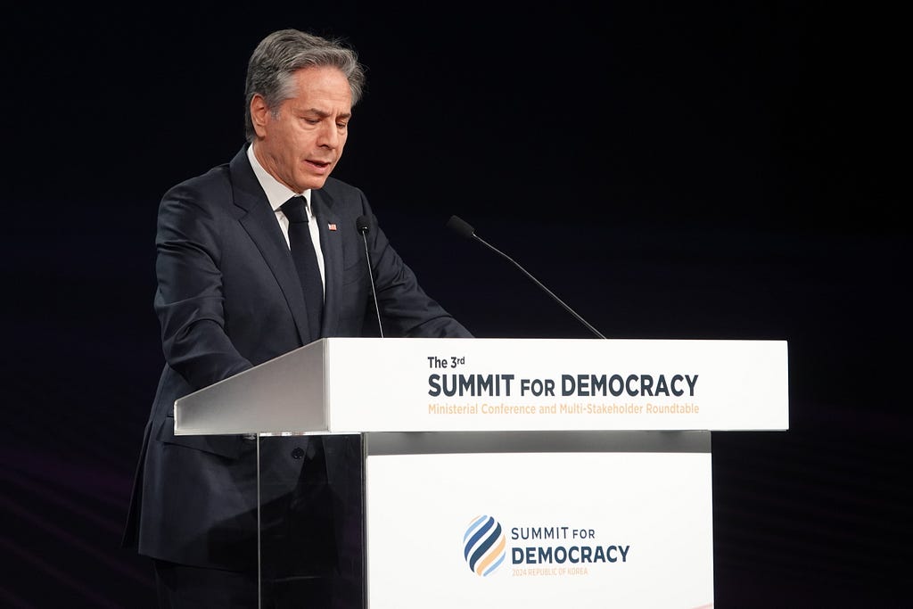 U.S. Secretary of State Antony Blinken stands behind a podium at the 3rd Summit for Democracy.