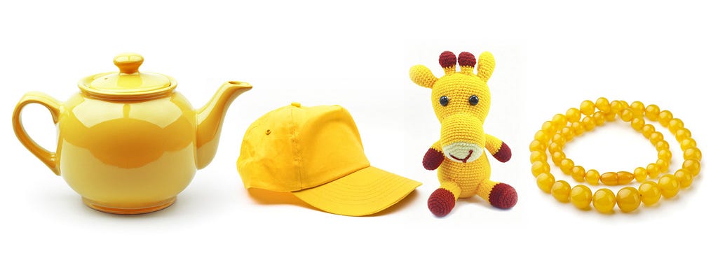 This is a picture of four everyday objects, including a teakettle, a baseball cap, a toy giraffe, and a necklace, that are all colored the same hue of bright yellow.