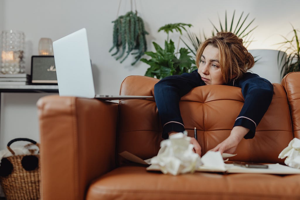 Woman stressed, staring at computer screen