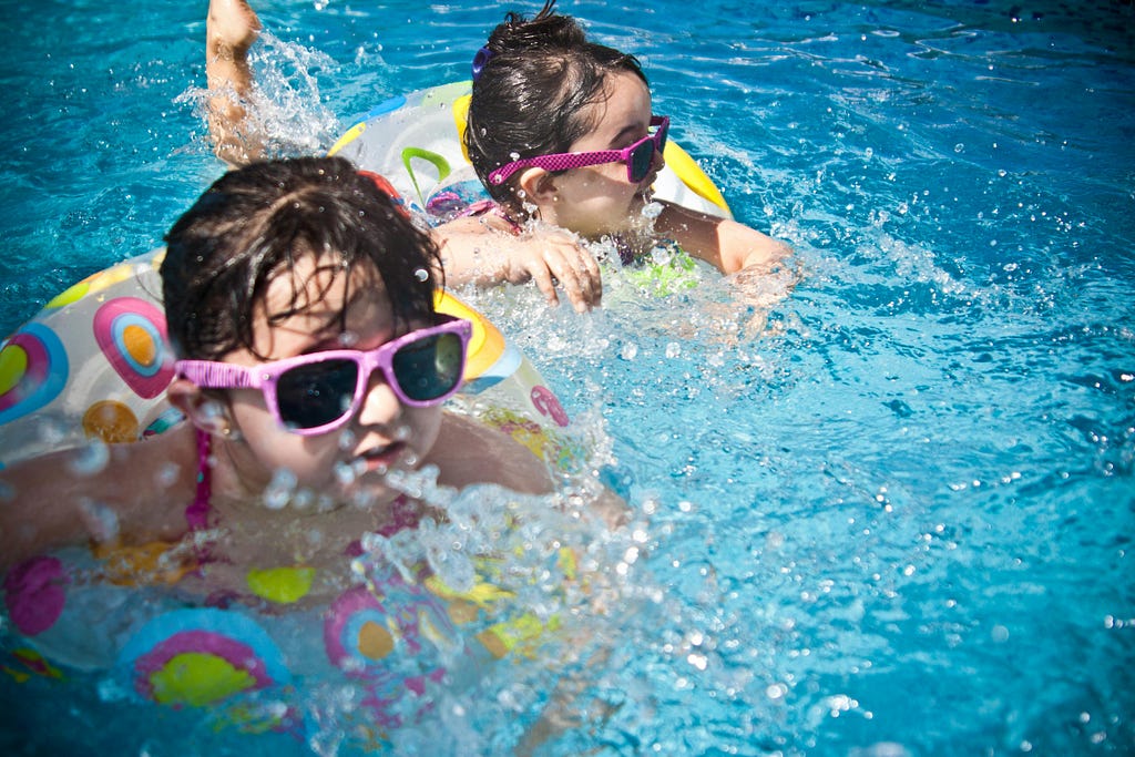 Little kids swimming in a pool