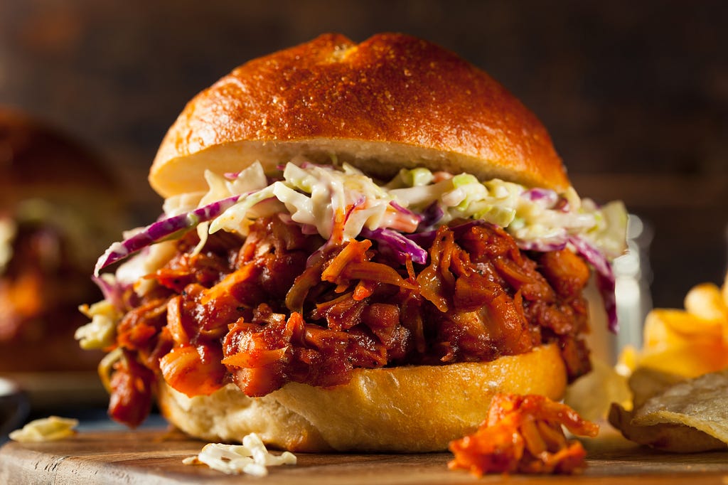 Jackfruit pulled pork topped with cole slaw between 2 buns