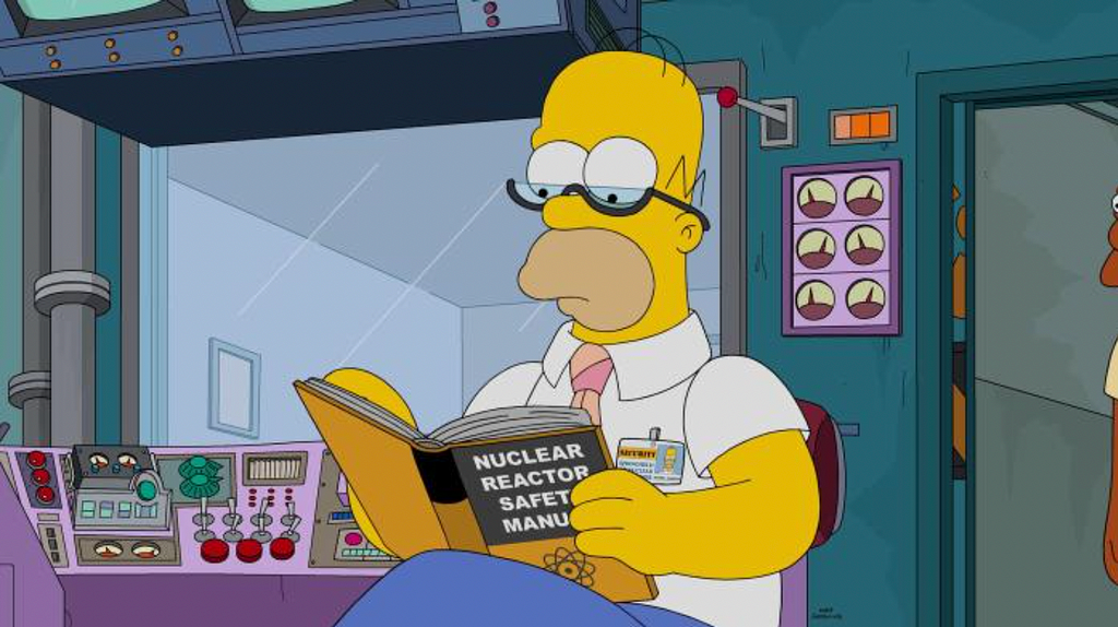 Homer Simpson reading a manual at work