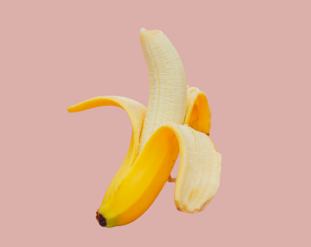 Peeled banana on a plain pink background.
