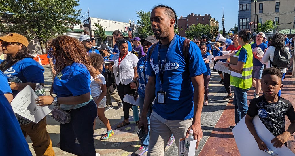 Photo of BTU members and supporters in a mass picket line around the Bolling Building. The next two photos show other scenes from the picket line.