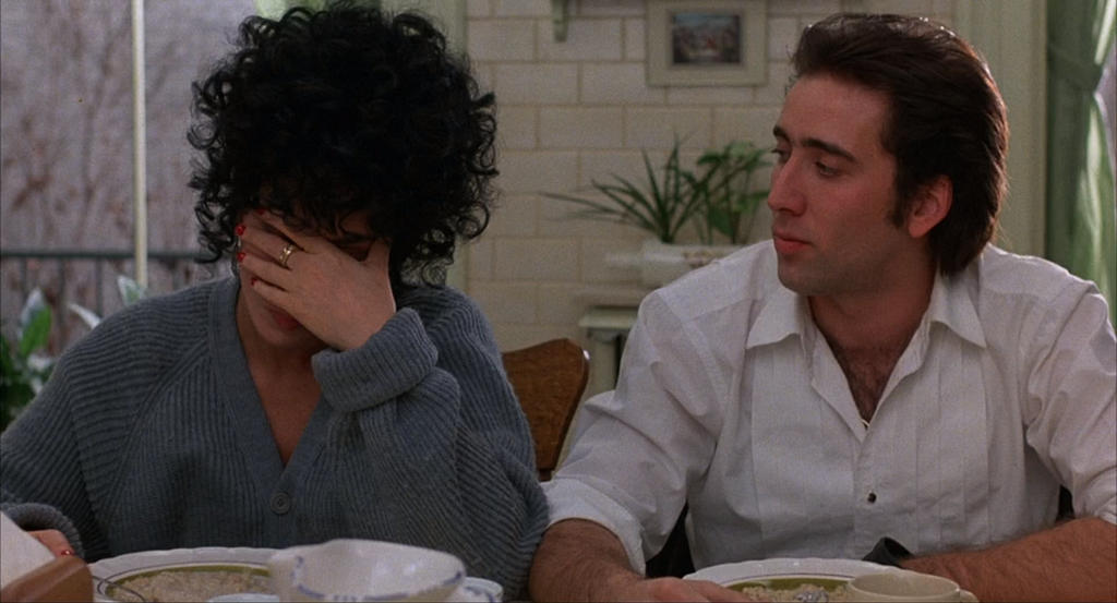 Cher covers her face while Nicholas Cage looks on in this still from Moonstruck.