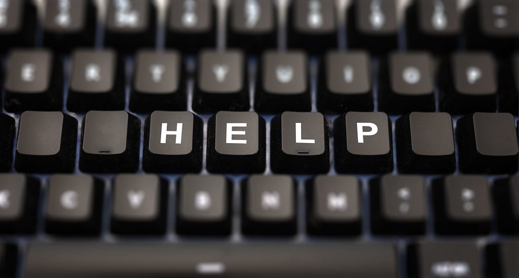 Computer keyboard with the keys spelling out the word “HELP”.