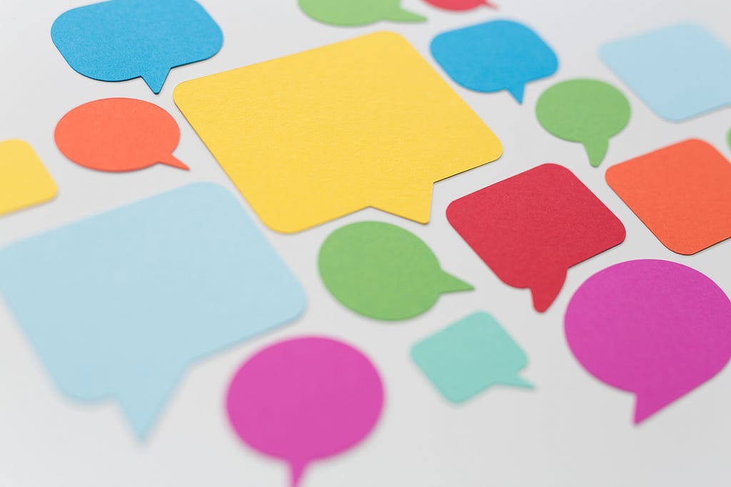 image of a variety of colorful speech bubble paper cut-outs on a white background