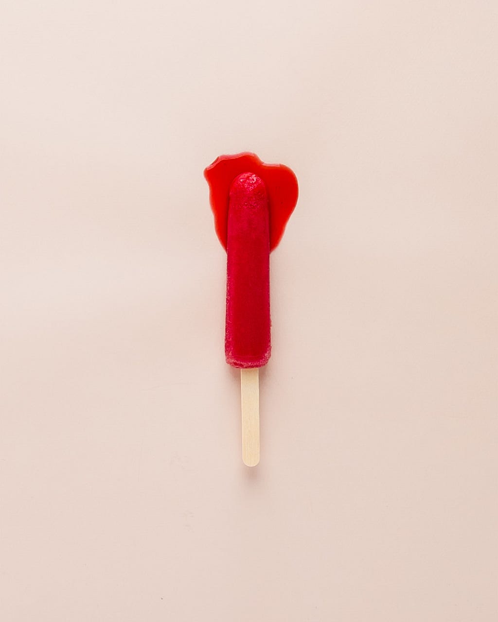 A melting red popsicle resmbling a used tampon