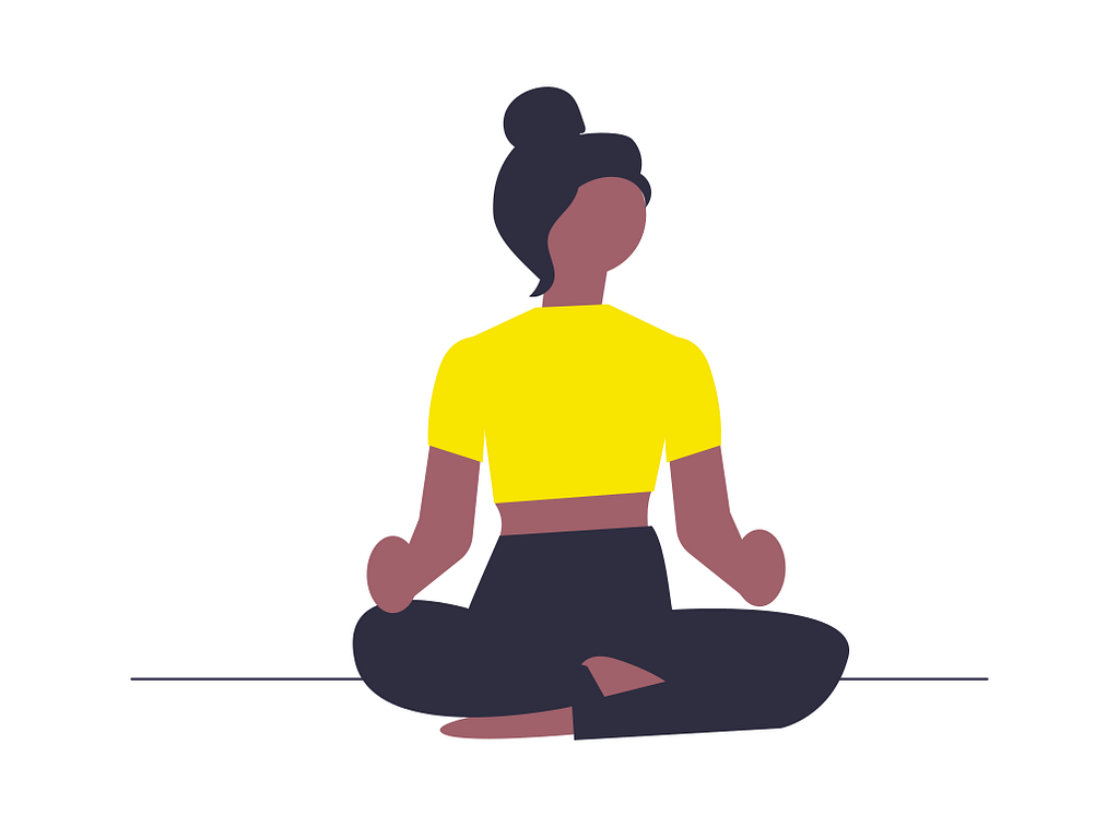 A woman sits in Padmaasana (lotus pose) and meditates.
