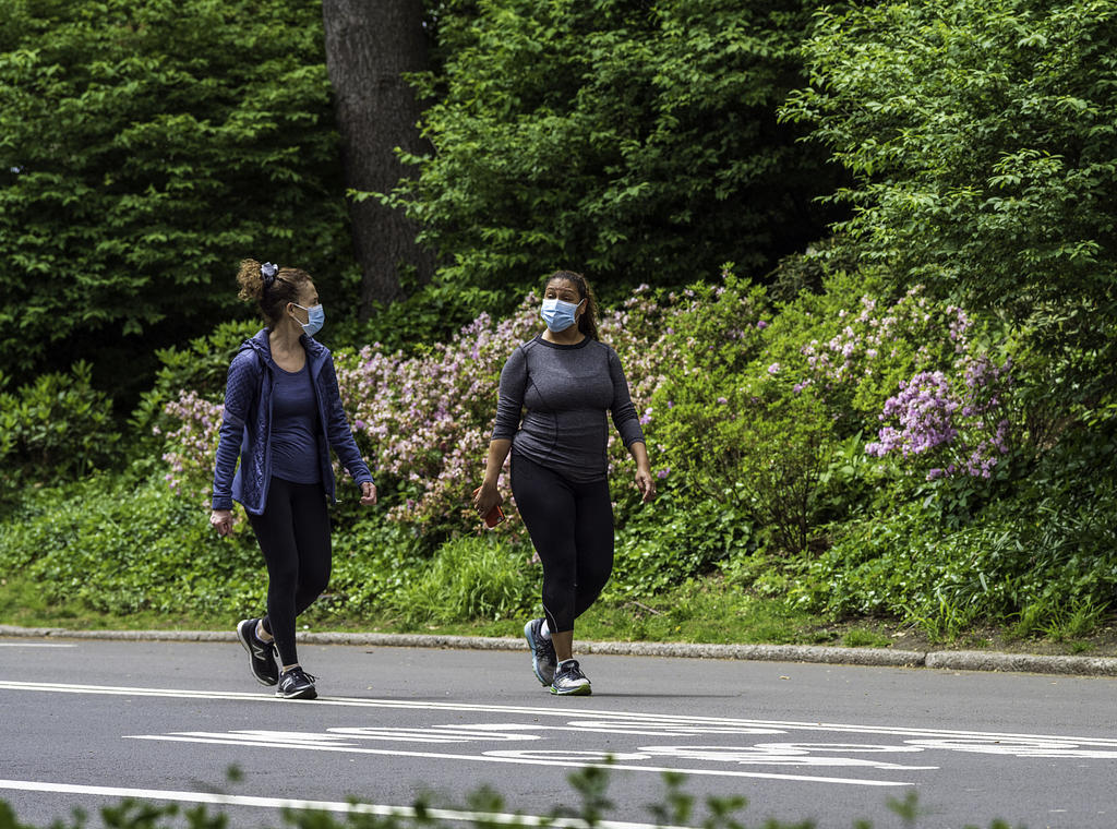 Women walking wearing masks