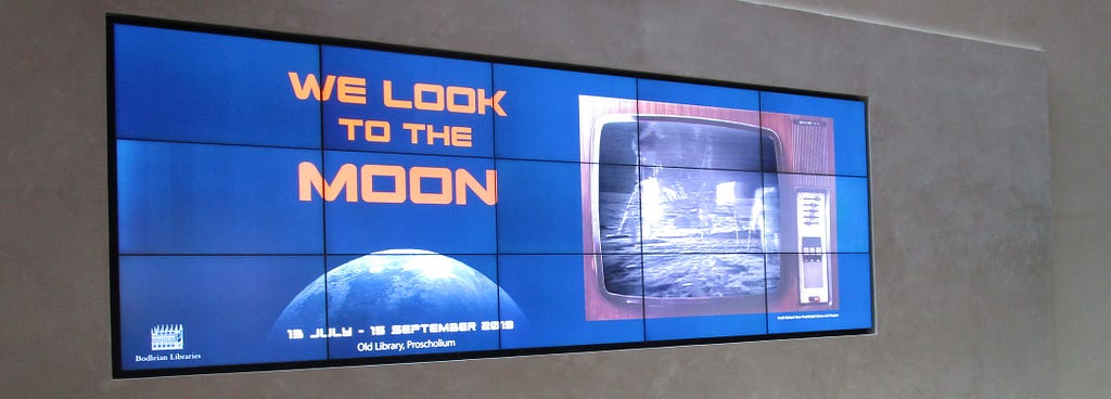 Heritage screen in Blackwell Hall, Bodleian Library, with Moon landing footage playing