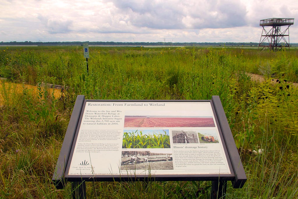 Interpretive sign in front of prairie landscape