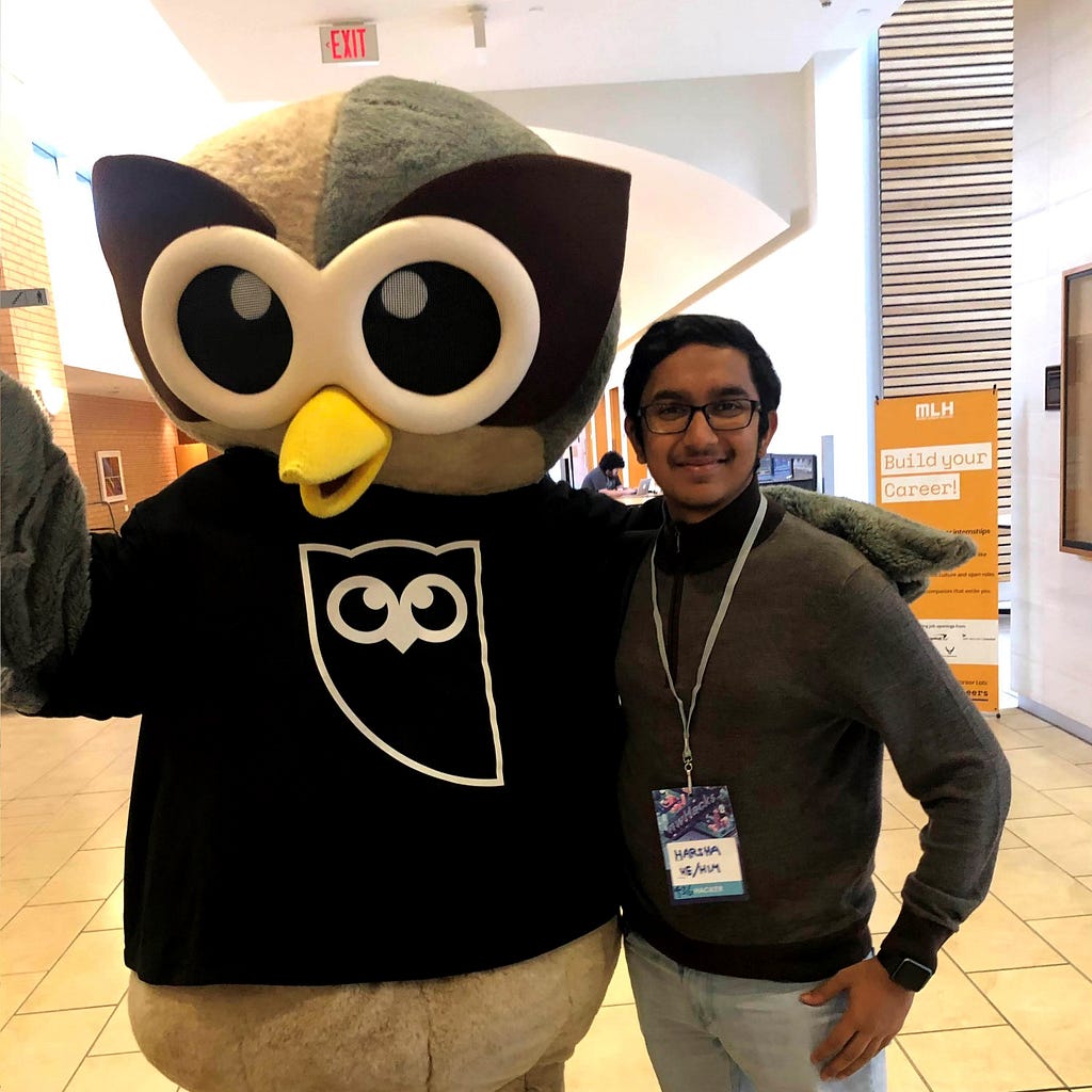 Campus Ambassador Harsha posing with the owl mascot from Hootsuite.