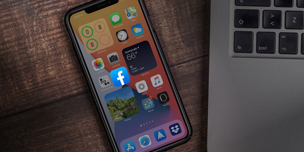 An iPhone with the Facebook app displayed on the screen.
