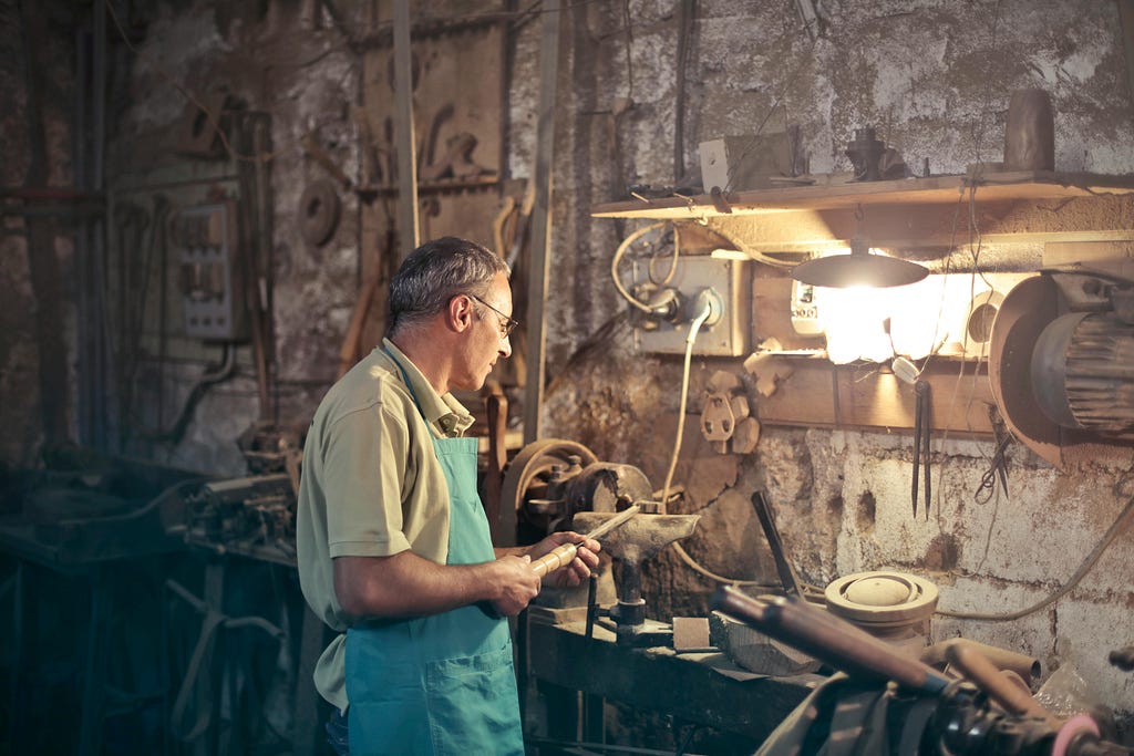 Photo by Andrea Piacquadio: https://www.pexels.com/photo/photo-of-man-standing-inside-his-workshop-3811832/