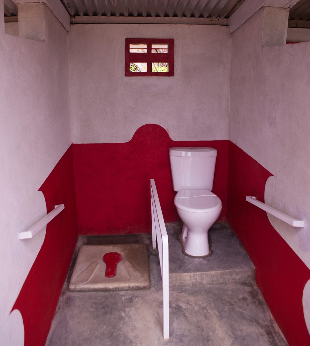 A latrine that has been constructed to be accessible to people with visual and motor impairments.