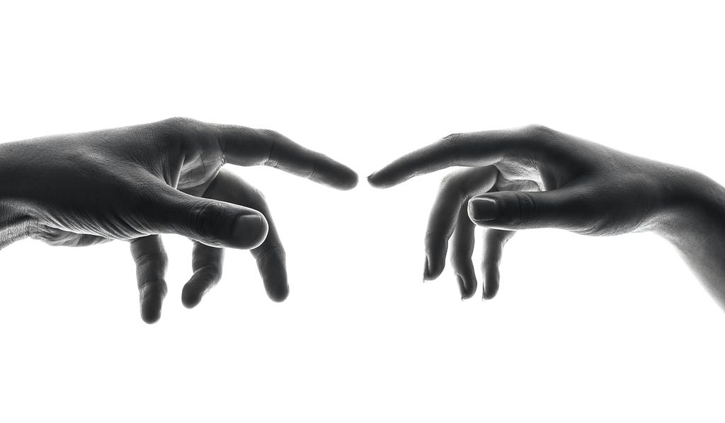 Two hands reaching toward one another, courtesy Shoeib Abolhassani, Unsplash (ukDEbYnyDsU)