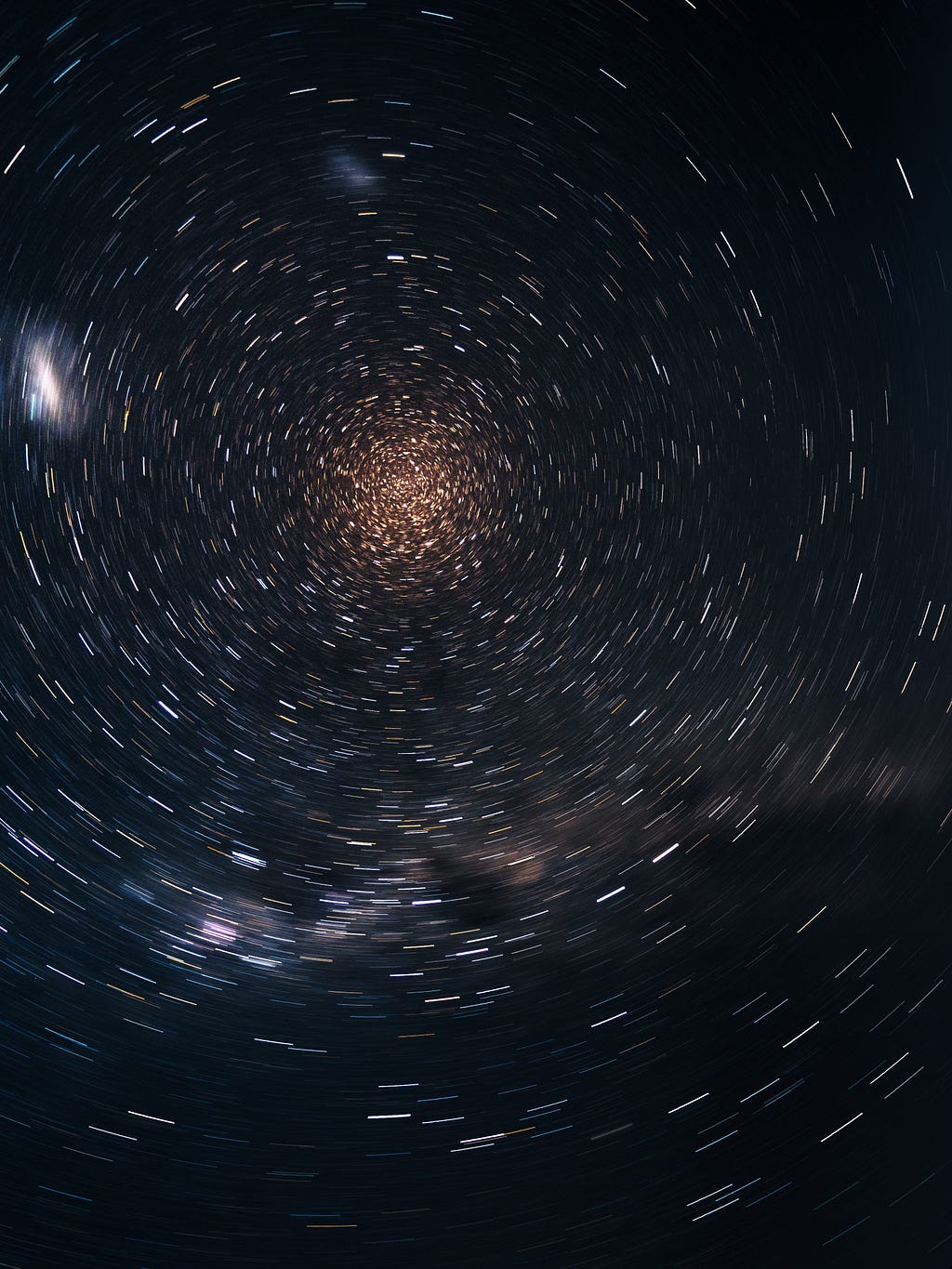 A swirling image of stars from a long exposure lens — photo courtesy of Mark Piwnicki on Unsplash