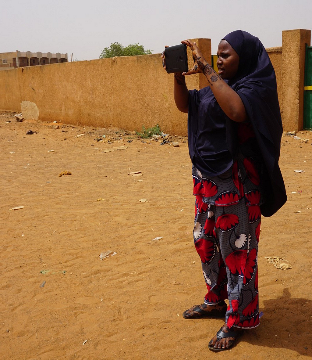 Halidou Beidou Rachidatou uses her tablet to take a photo of an integrated health center in Niger.