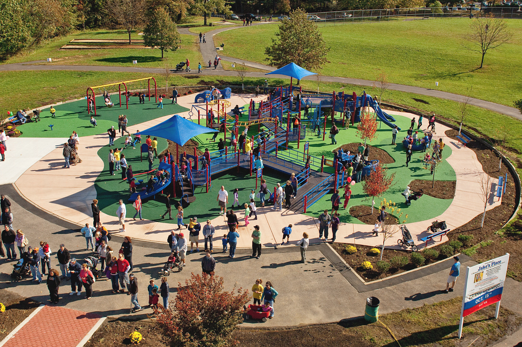 Colorful Universal Design playground with children interacting