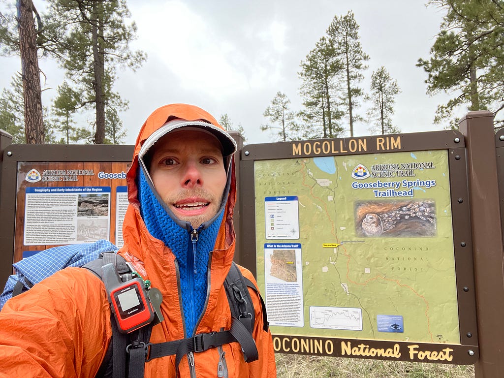 Me standing in front of a trailhead sign.