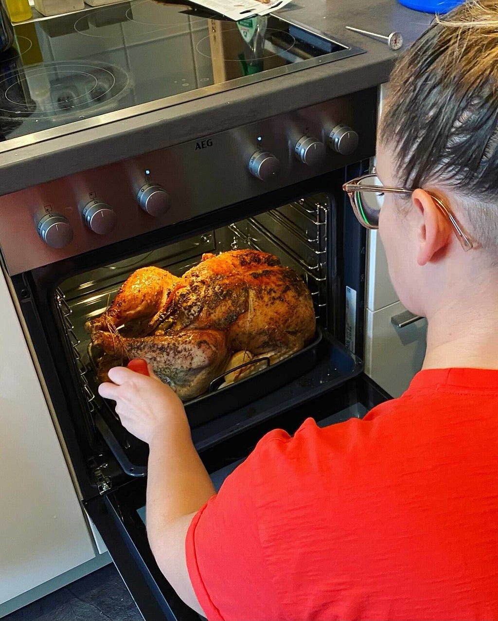 Lauren, basting a giant turkey in preparation for Thanksgiving in Germany