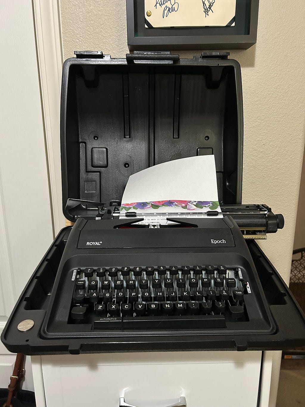 Manual typewriter with a piece of paper fed into the top