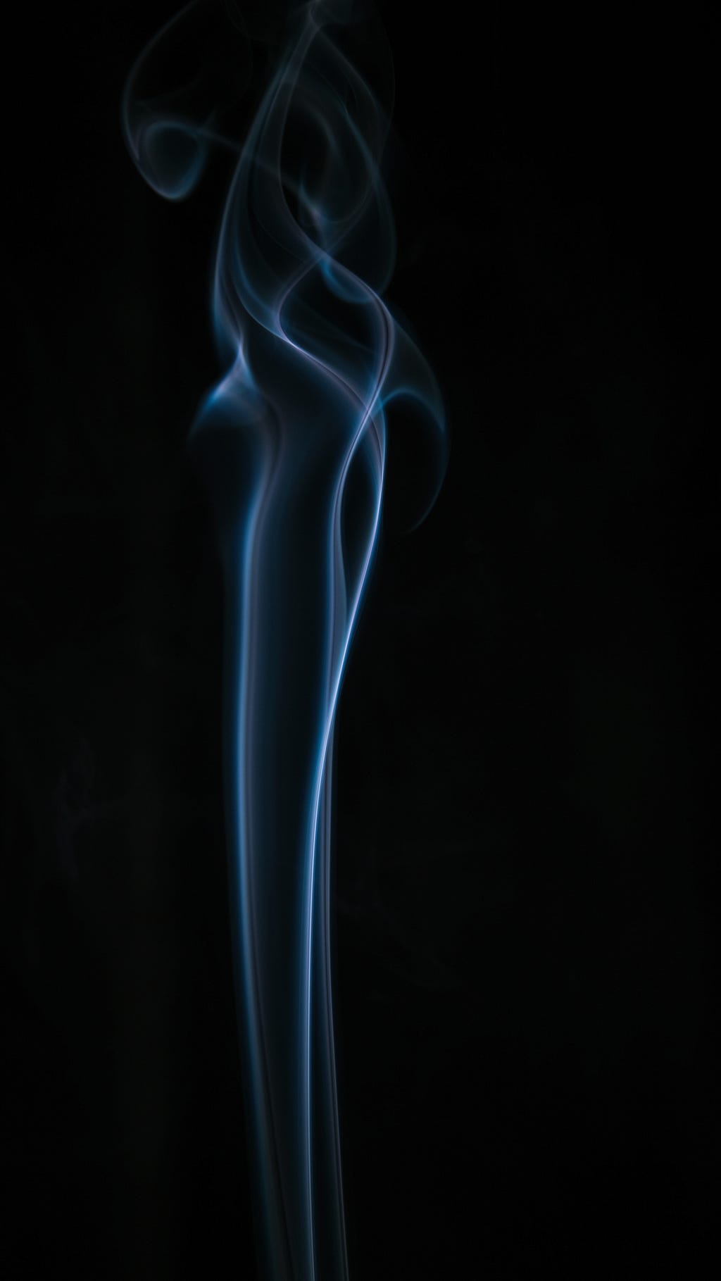A long vertical puff of blue smoke set against a black background.