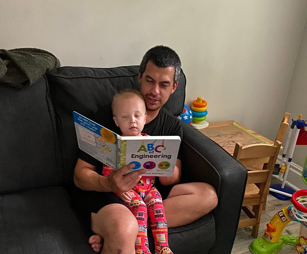 a dad reading to his son