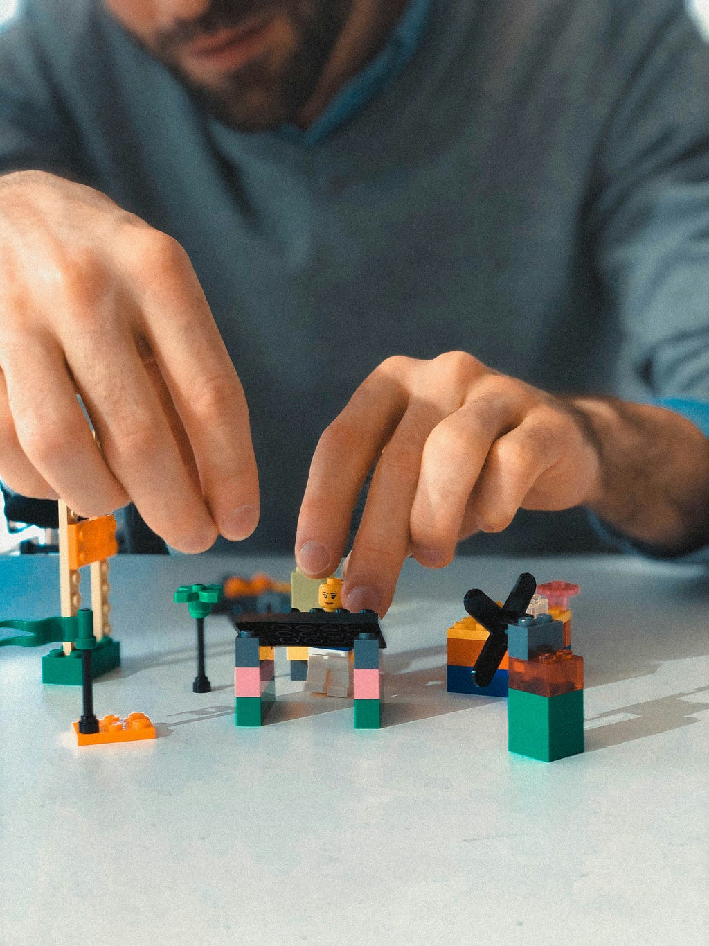 A man building around a Lego figurine meant to represent how digital ecosystems should be user-centric