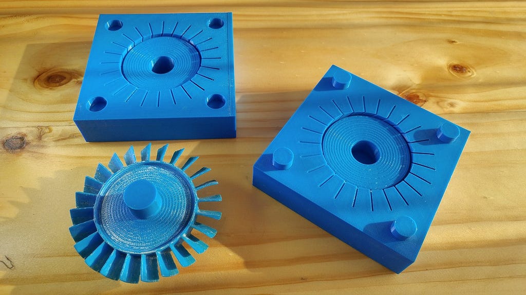 These are 3D-printed molds to make a plastic propeller blade. After only a few uses, the molds begin to show wear, tear, and warping from the rapid heating and cooling of plastic.