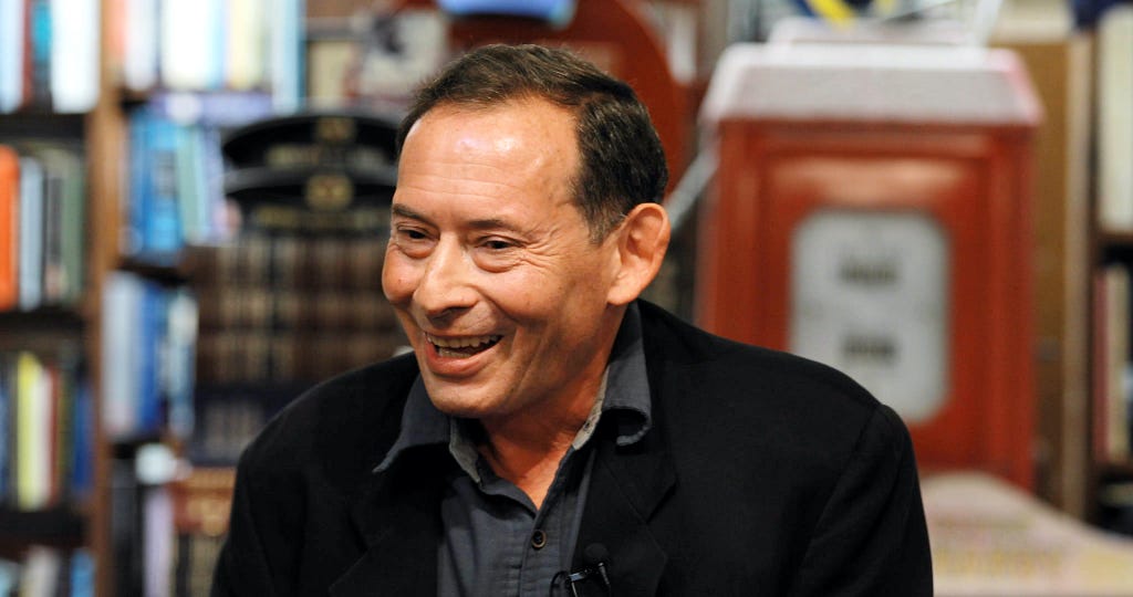 Neuroscientist David Edelman smiling during a talk at DG Wills Bookstore.