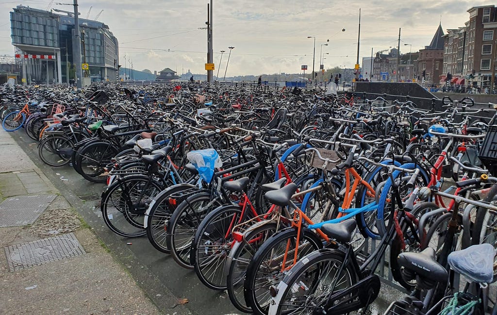 A large amount of bycicles piled together at the central station in Amsterdam