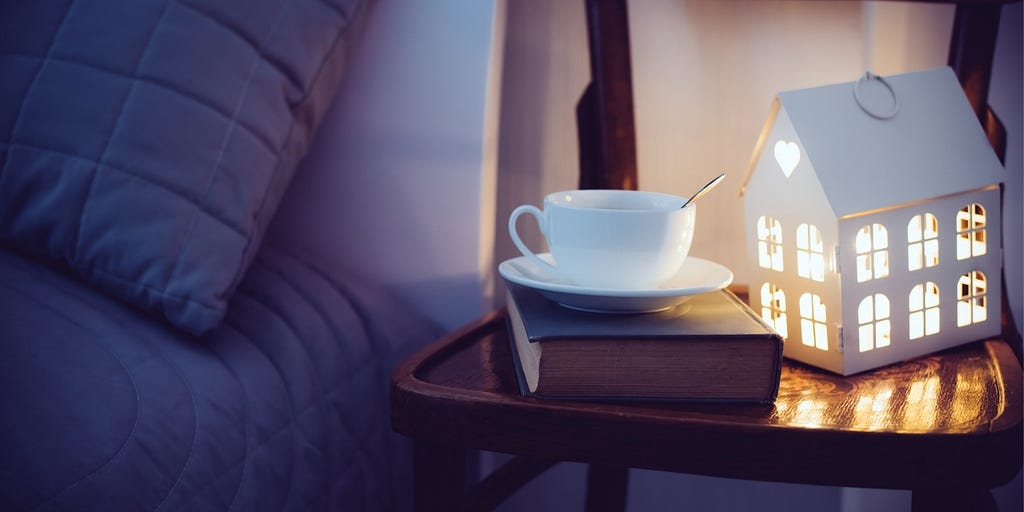 Evening bedside with cup of tea and beautiful home nightlight