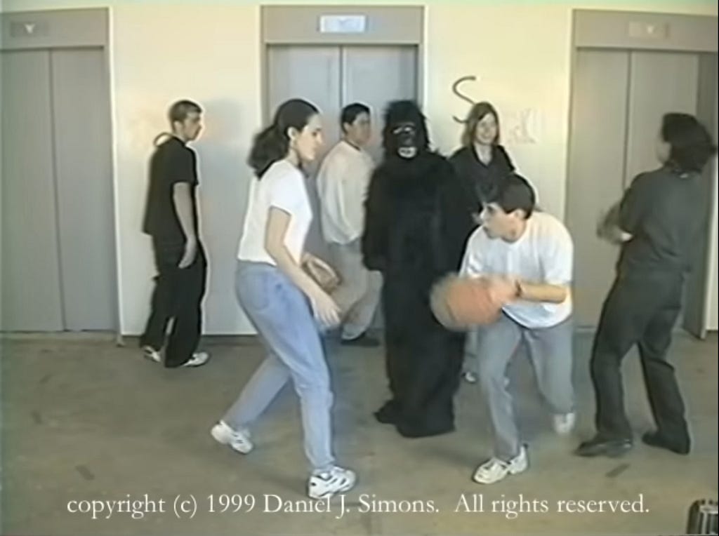 A person dressed up as a gorilla stands in the middle of 6 people who are passing a basketball to each other.